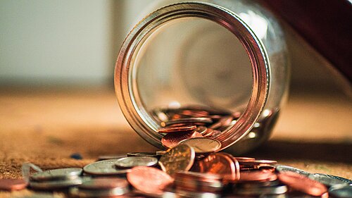 Coins coming out of a jar